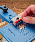 Corner Key Doweling Jig for Decorative Mitered Joints With Molded Reference Lines and Drill Guides in use on wood surface