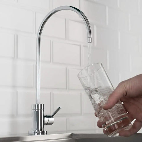 Purita Lead-Free Kitchen Water Filter Faucet dispensing water into glass, 100 Percent Lead-Free Brass Body and Waterlines, Chrome Finish.