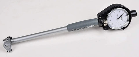 Side view of Fowler cylinder dial bore gauge with 6-inch range; gray handle, silver rod, white dial