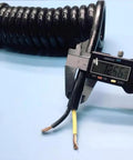 Close-up of Badass Heavy Duty Retractable Coiled Extension Cord measuring 12.56mm diameter, showcasing 2 core electrical wire.