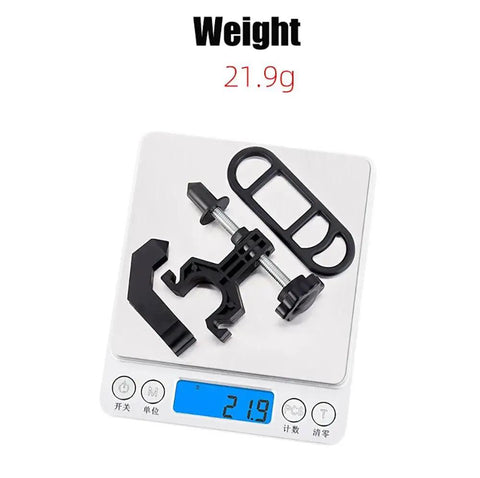 Portable Bicycle Wheel Truing Stand On The Go components on scale showing 21.9g, made of black ABS and stainless steel