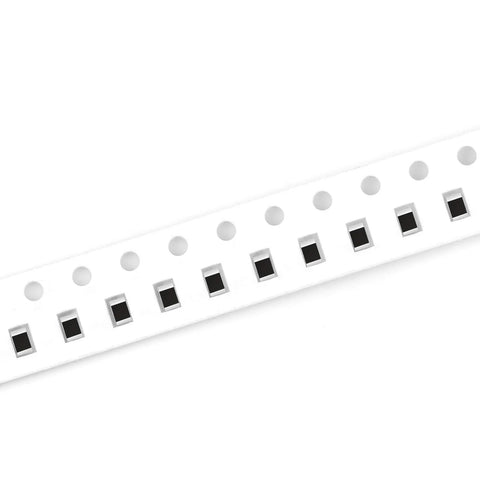 Angled side view of SMD 0805 resistor tape on white carrier strip with black chip resistors.