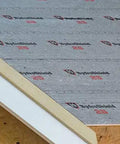 Heavy Duty Synthetic Roof Underlayment Waterproof Felt Alternative With Bold Preprinted Nailing Lines Top Shelf Stock shown laid flat on a roof.