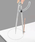 Tough As Nails All Metal Drafting Compass With Adjustable Wing Divider And Secure Pencil Holder in use on white paper.