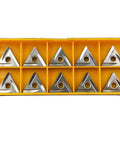 Ten TNMG carbide inserts in a yellow plastic case; triangular with central hole.