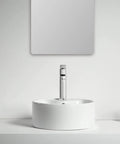 Straight Fire 15.7 Inch Diameter Round Ceramic Bathroom Vessel Sink With Integrated Faucet For Above Counter Installation And Quick Room Glow Up In Crisp White Finish on countertop with a mirror above.