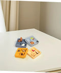 Four Piece Miniature Dollhouse Platter Set With Realistic Four Grid Resin Box For Candy And Nuts on a table