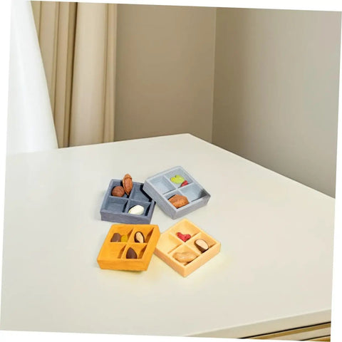 Four Piece Miniature Dollhouse Platter Set With Realistic Four Grid Resin Box For Candy And Nuts on a table