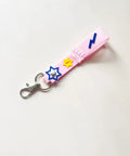 Grab These Slick Swivel Clasp Hooks Solid D Ring Key Chain Clips Heavy Duty Lobster Claw Snaps Smooth Trigger Clips Perfect For Hitching Lanyards Decking Out Crafting Purses And Bag Gear In Classic Silver, featuring a pink lanyard with decorative stars.