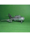 MiG-15 UTI Midget 1/48 Scale Model Kit With 137 Parts Over Eight Inches Long Detailed Plastic Aircraft Build Set on green background.