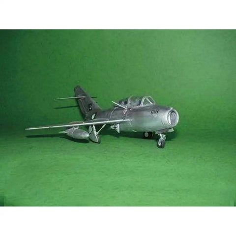 MiG-15 UTI Midget 1/48 Scale Model Kit With 137 Parts Over Eight Inches Long Detailed Plastic Aircraft Build Set on green background.