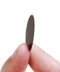 Top Notch 108 Piece Self Adhesive Screw Hole Plugs 20Mm Black Walnut Wood Grain Finish, held between fingers for easy application.