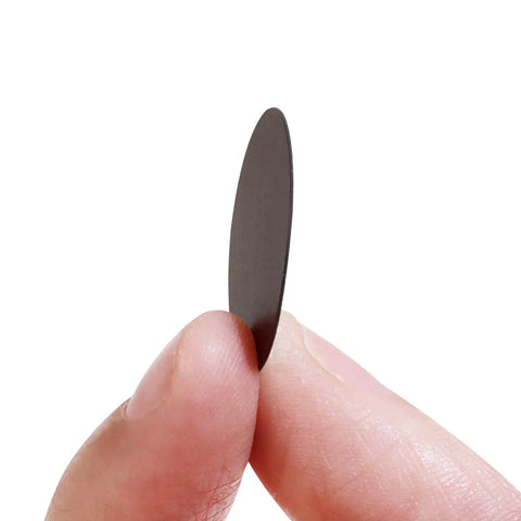 Top Notch 108 Piece Self Adhesive Screw Hole Plugs 20Mm Black Walnut Wood Grain Finish, held between fingers for easy application.