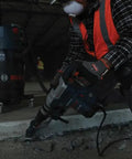 Worker using Heavy-Duty SDS Max Rotary Hammer Drill, 13 Amp, 120V, 6.5 ft-lbs Impact Energy at construction site