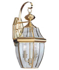 Lancaster Traditional Two Light Outdoor Wall Lantern in Polished Brass Finish showcasing curved beveled glass exterior for porch