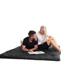 Couple sitting on All Season Double Sleeping Bag For Adults With 2 Pillows Queen Size XL Waterproof Camping Gear For Two