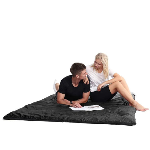 Couple sitting on All Season Double Sleeping Bag For Adults With 2 Pillows Queen Size XL Waterproof Camping Gear For Two