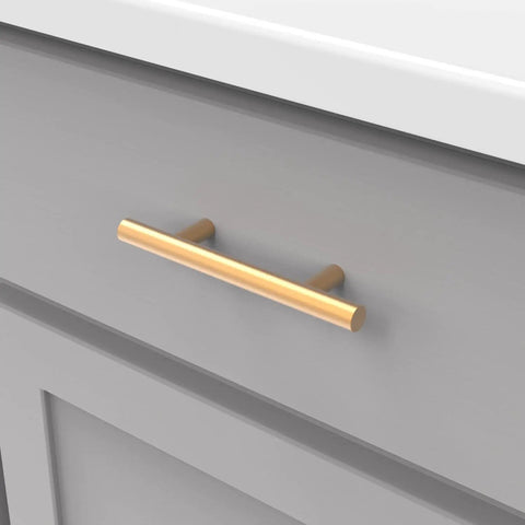 10 Pack 3-Inch Center Cabinet Handles with Brushed Brass Finish, modern bar pull on gray drawer front.