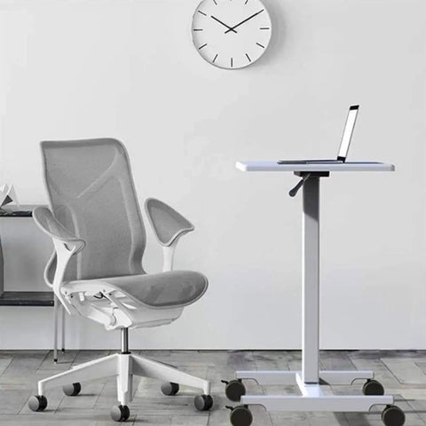 Hella Sturdy Height Adjustable Mobile Standing Desk With Smooth Glide Casters And Rustproof White Steel Top Portable Laptop Workstation And Rolling Podium For Home Office Space beside a modern ergonomic chair.