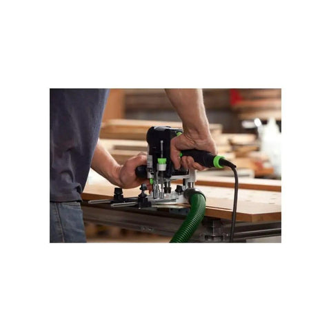 Using Plunge Router Of 1400 EQ-F-Plus With Ergonomic Grip for precise woodworking on a bench, close-up angle.