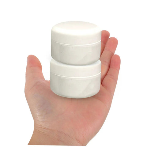 Hand holding two jars of Ceramic Tile Repair Kit 2 Pack Quick Drying Adhesive For Cracks And Chips DIY Friendly Easy To Use Mending Agent
