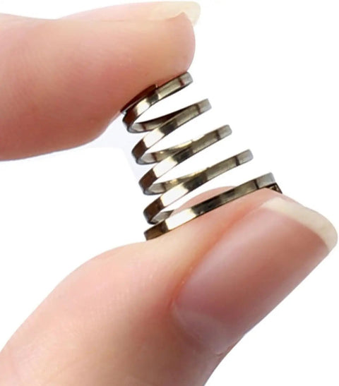 Close-up of hand holding stainless steel spring from Universal Stainless Steel Quick Release Skewer Springs Kit For Mountain And Road Bikes 10 Pack Durable Hub Lever Springs For Secure Wheel Attachment Rust Resistant And Easy To Install.
