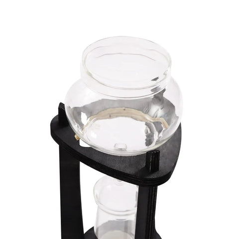 Kick Back And Sip Smooth Chills With This Sharp Cold Brew Drip Coffee Maker Crafted From A Borosilicate Pitcher And Real Wood Stand For Hassle Free Iced Coffee Runs That Come Out Fresh And Totally On Point Daily - top view of borosilicate glass pitcher on wooden stand.