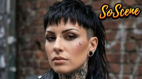 Person with facial and ear piercings including dermal top jewelry, viewed in urban setting.