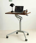 Upgrade Your Home Office Setup With This Smooth Riding Mobile Standing Desk That Dials In Your Perfect Height Fast For Seamless Sit Or Stand Flexibility Wherever You Roll. Mobile standing desk with walnut top and adjustable height.