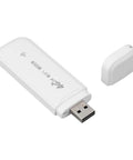 Hella Portable 4G LTE Wireless Router With Solid Battery Life And Zero Lag Signal For Road Trippers Desk Grinds Or Couch Lounging Across Europe With Slick Compact Design And Simple Plug In Setup, shown in white with USB connection.