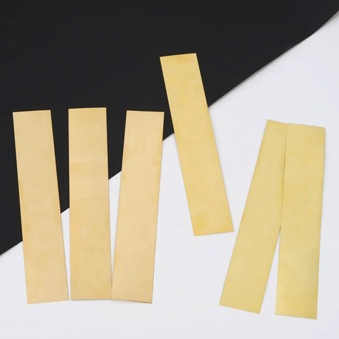 Brass Shim Stock Set, 18 Pcs Rectangular Shims 5.9 x 0.98 Inch With 6 Thicknesses, shown loose on black and white background.