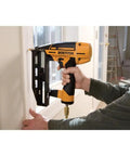 Person using Finish Nail Gun 16 Gauge Pneumatic Nailer with Clip Head Design on interior trim