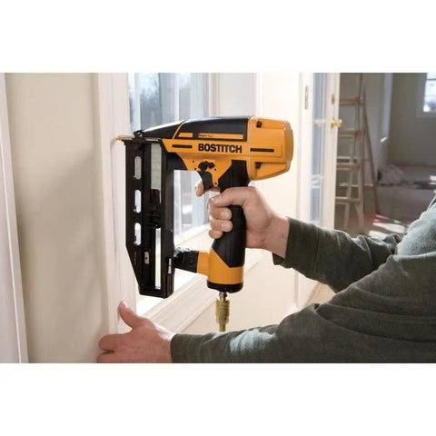 Person using Finish Nail Gun 16 Gauge Pneumatic Nailer with Clip Head Design on interior trim