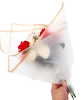 Hand holding bouquet wrapped in Floral Bouquet Wrapping Paper Waterproof Protective Wrap Paper 20 Sheets Cuttable