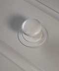 Close-up of Two Pack XL White Bi Fold Closet Dummy Doorknob with Wide Backplate for Wardrobe Dresser Kitchen Cabinets