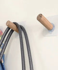 Close-up of 6 Piece Extra Long Wooden Wall Hooks Self Adhesive Coat Rack For Doors, holding bags. Easy peel stick, heavy duty.