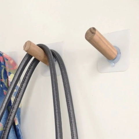 Close-up of 6 Piece Extra Long Wooden Wall Hooks Self Adhesive Coat Rack For Doors, holding bags. Easy peel stick, heavy duty.