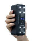Rockit Wireless Laser 3D Scanner With 38 Blue Laser Lines held in hand, showing front view with lights and camera lenses visible.