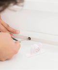 Installation of 10 Pack White ABS Cabinet Door Latch Double Roller Catch Hardware with screwdriver next to latch component