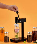 Manual Pull Tab Can Sealer in use with glass jar, lightweight aviation aluminum body and iron base for home and commercial use.