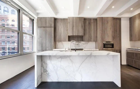 Modern kitchen featuring a marble countertop, reclaimed wood cabinetry, and large windows for natural light.