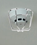 Fire Sprinkler Head Guard Protective Cover Cage Ceiling Impact Resistant Shield mounted on the ceiling, showing its protective design.