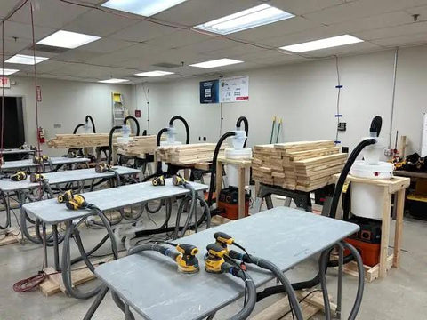 Workshop with Quick Click 16 Foot Commercial Vacuum Hose With Expanded Multi Brand Power Tool Adapter Set connected to tools
