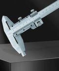 YMGSCC Household 300mm Vernier Caliper measuring on a metallic surface with clear markings for accurate readings.