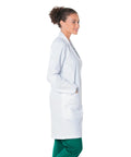 Side profile of a woman wearing a Relaxed Fit Five Pocket Three Button Full Length White Medical Lab Coat For Women.