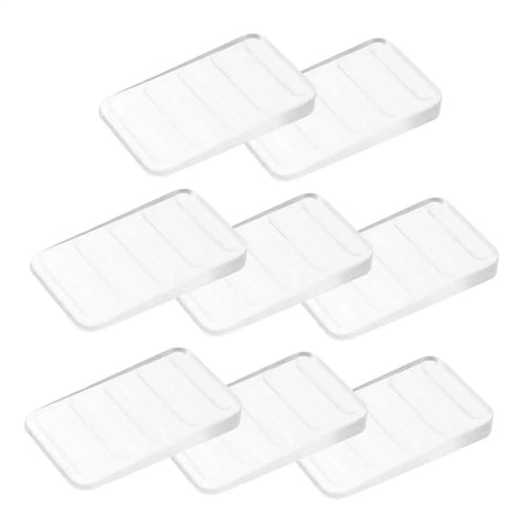 Big Time Game Change 32 Piece Clear Plastic Leveling Shims For Furniture Stabilizers arranged in stacks.