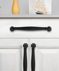 10 Pack 4 Inch Hole Center Matte Black Heavy Duty Solid Cabinet Pulls installed on white cabinet doors and drawers.