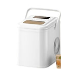Slick Countertop Portable Nugget Ice Maker With Hella Quick Freezing Ability And Easy Self Cleaning System Holding Twenty Six Pounds Of Chunky Ice, white finish with drink glass beside.