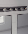 Donelson Vanity Light In Natural Iron Finish mounted above mirrors in bathroom, showing five E26 bulbs, transitional modern design.