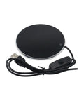Badass Portable Cup Warmer And Coffee Mug Heating Coaster Offering Smart Thermostatic Temperature Control For Hot Milk Tea Or Water showing a round black heating pad with USB cable.